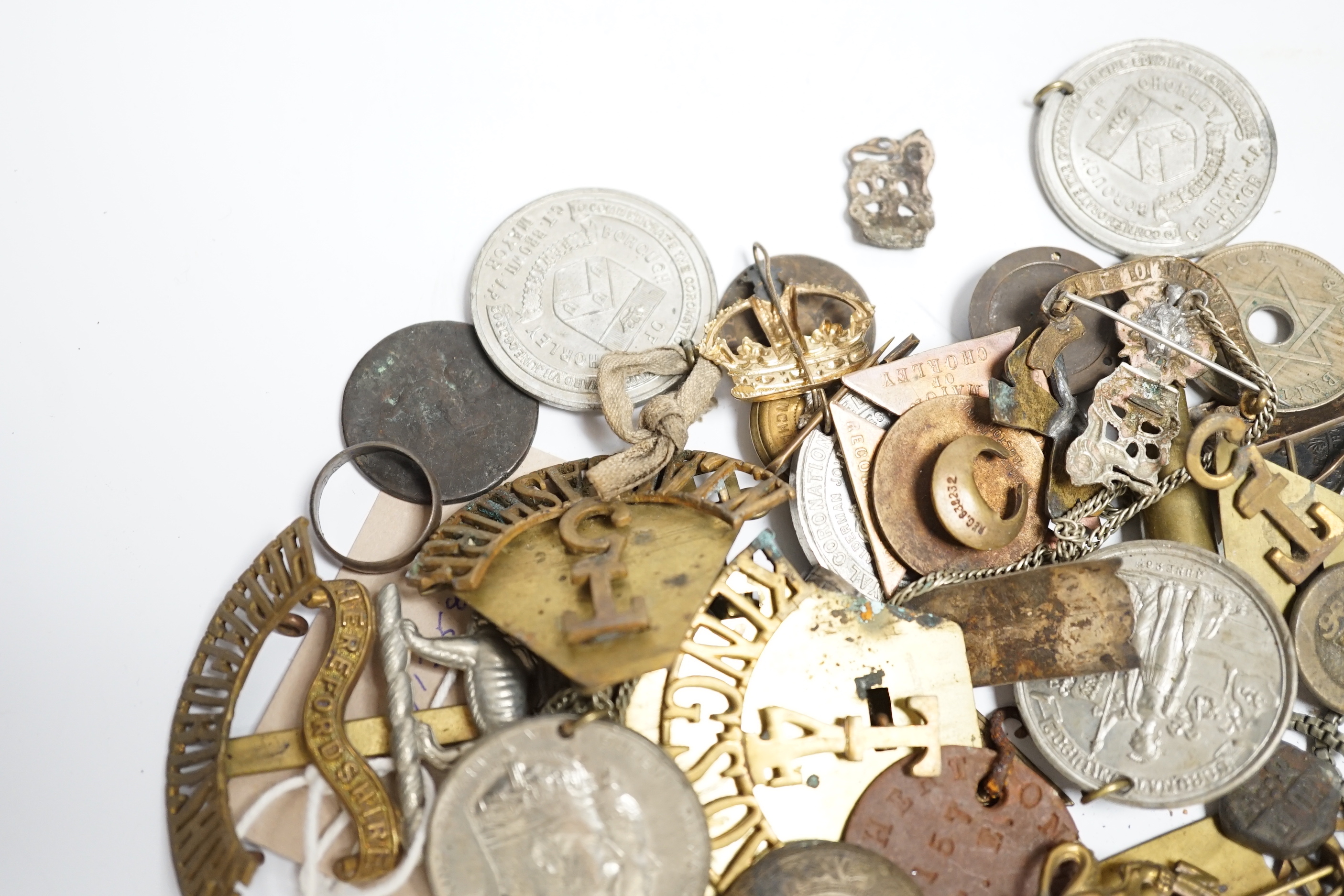 A quantity of military cap badges, etc.
